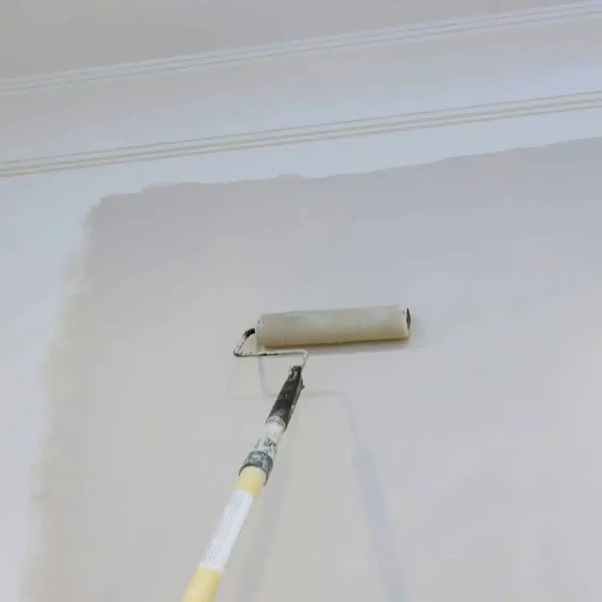 male-hand-painting-wall-with-paint-roller-painting-apartment-renovating-with-color-paint-scaled